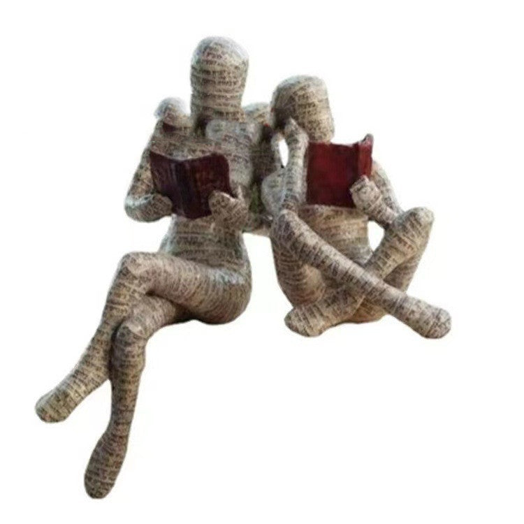 A Woman Reading A Paper Pulp Molding Ornament Tree