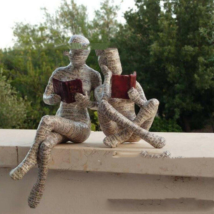 A Woman Reading A Paper Pulp Molding Ornament Tree