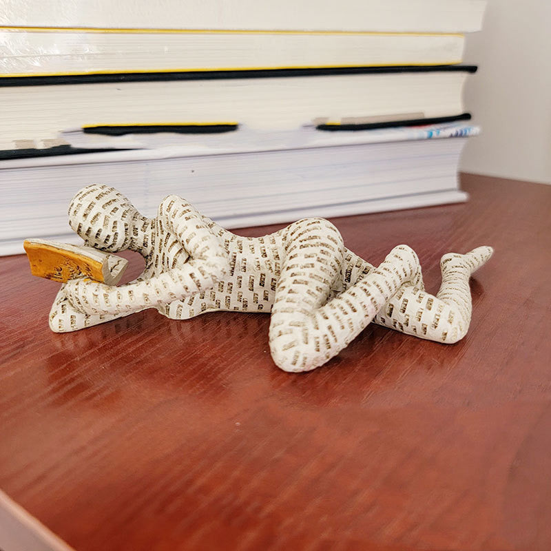 A Woman Reading A Paper Pulp Molding Ornament Tree